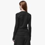 Back view of a woman wearing a long sleeve black t-shirt